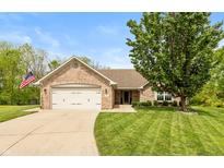 Charming single-story brick home featuring an attached two-car garage and well-manicured lawn at 35 Valley View, Brownsburg, IN 46112