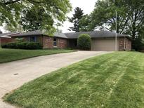 Charming brick ranch-style home with well-manicured lawn and attached two-car garage at 3619 31St St, Columbus, IN 47203