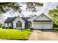 Charming brick home with a well-manicured lawn, arched window, and an attached two-car garage at 51 Glasgow Ln, Noblesville, IN 46060