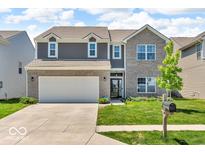Charming two-story home with a well-manicured lawn and a two-car garage at 5256 Bramwell Ln, Whitestown, IN 46075