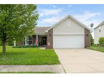 Charming single-Gathering home featuring a brick and siding facade with an attached two-car garage at 5957 Haywood Ct, Greenwood, IN 46142