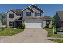 Two-story home with a brick and vinyl facade, blue shutters, a two-car garage, and a well-manicured lawn at 6491 Enclave Blvd, Greenwood, IN 46143