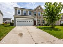 Charming two-story home featuring stone accents, a two-car garage, and a well-manicured front yard at 6683 School Branch Dr, Brownsburg, IN 46112
