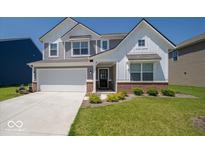 Charming two-story home with a two-car garage and well-manicured lawn at 7234 Darley Ln, Indianapolis, IN 46259
