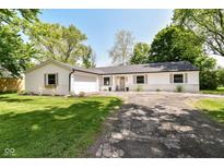Charming single-story home with a well-manicured lawn and classic curb appeal at 7771 Delbrook Dr, Indianapolis, IN 46260