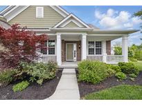 Charming brick home featuring a covered front porch with classic white columns and inviting curb appeal at 902 Racetime Rd, Westfield, IN 46074
