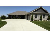 Charming single-story home featuring a stone facade, well-manicured lawn, and spacious driveway at 920 Alba Dr, Lebanon, IN 46052