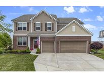 Charming two-story home featuring brick and siding, a well-manicured lawn, and an attached two-car garage at 952 Workington Cir, Westfield, IN 46074