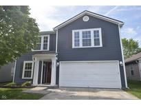 Charming two-story home with blue siding, white trim, and an attached two-car garage at 9613 W Stargazer Dr, Pendleton, IN 46064