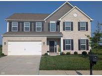 Charming two-story brick home with a two-car garage and well-manicured lawn in a suburban neighborhood at 9860 Gallop Ln, Fishers, IN 46040