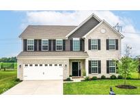 Beautiful two-story home with a white brick facade, black shutters, and a well-manicured front lawn at 9860 Gallop Ln, Fishers, IN 46040