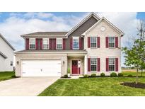 Charming two-story home with light brick, red shutters, a two-car garage, and a well-manicured lawn at 9860 Gallop Ln, Fishers, IN 46040