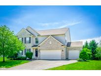 Charming two-story home featuring a three car garage, brick accents, and well-manicured landscaping at 10075 Niagara Dr, Fishers, IN 46037