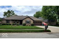 Charming brick home featuring a well-manicured lawn and an attached two-car garage with a beautiful roof at 1102 Redwood Dr, Brownsburg, IN 46112