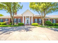 Beautiful brick home with manicured landscaping and a charming front porch, perfect for relaxing at 1105 Deer Creek Dr, Anderson, IN 46011