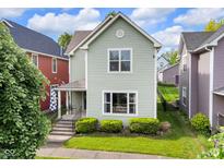 Charming two-story home featuring a well-maintained lawn and traditional architectural details at 1311 E Michigan St, Indianapolis, IN 46202