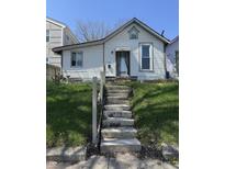 Charming home featuring a quaint facade, concrete steps, and green lawn, ready for renovation and landscaping at 1314 Laurel St, Indianapolis, IN 46203