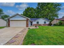 Charming single-story home with a well-manicured lawn and a brick and siding exterior at 1604 Stacy Lynn Dr, Indianapolis, IN 46231