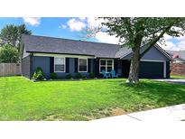 Charming home features a well-manicured lawn, blue siding, and a two-car garage at 170 Briar Hill Dr, Whiteland, IN 46184