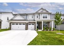Charming two-story home featuring a three-car garage, brick accents, and a well-manicured lawn at 19442 Honeylocust Glen, Noblesville, IN 46062