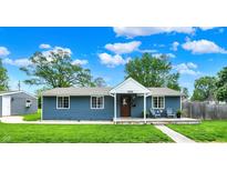 Charming blue house with a welcoming front porch, perfect for relaxing outdoors and enjoying neighborhood views at 2303 Midway St, Columbus, IN 47201