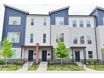 Attractive townhomes with blue and gray siding, black doors, and well-manicured landscaping at 3110 W New York St, Indianapolis, IN 46222