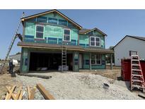 Two-story home under construction with visible framing and protective wrap, showcasing its new construction status at 3321 Godby Dr, Sheridan, IN 46069