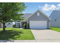 Charming home with a well-maintained lawn, inviting curb appeal, and a two-car garage at 3341 Enclave Xing, Greenwood, IN 46143