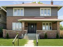 Charming brick two-story home with a well-manicured lawn and classic architectural details at 3370 N New Jersey St, Indianapolis, IN 46205