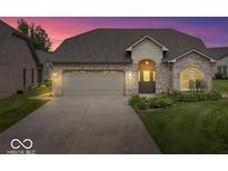 Charming brick home featuring an attached garage and manicured lawn, perfect for curb appeal at 4134 Bella Ct, Indianapolis, IN 46237