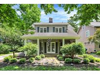 Charming two-story home with a covered front porch, manicured landscaping, and inviting curb appeal at 4527 Central Ave, Indianapolis, IN 46205