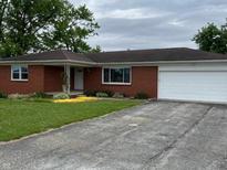 Charming brick ranch home with an attached garage and well-maintained front yard at 5457 W 900 North, McCordsville, IN 46055