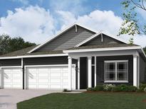 Charming home featuring a three-car garage, welcoming entrance, and traditional architectural details at 5863 Handbell Ln, Greenwood, IN 46143