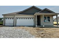 Charming single-story home with a two-car garage and inviting covered entry at 5863 Handbell Ln, Greenwood, IN 46143