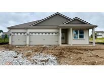 Charming single-story home with a three-car garage and neutral exterior color palette at 5863 Handbell Ln, Greenwood, IN 46143