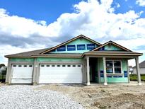 New construction featuring a two-car garage and a covered porch, showcasing modern design at 5863 Handbell Ln, Greenwood, IN 46143