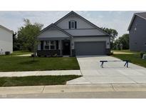 Charming single-Gathering home featuring gray siding, a two-car garage, and a well-manicured front lawn at 5863 Handbell Ln, Greenwood, IN 46143