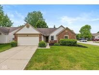 Charming single-story home featuring brick and vinyl siding, a two-car garage, and a well-manicured lawn at 6138 Bartley Ct, Indianapolis, IN 46236