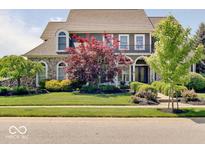 Charming two-story home with landscaped yard and stone accents, presenting excellent curb appeal at 6648 Westminster Dr, Zionsville, IN 46077