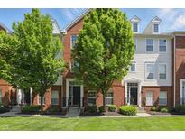 Charming townhome featuring brick and siding exterior with manicured lawn and mature trees at 1111 Cavendish Dr, Carmel, IN 46032