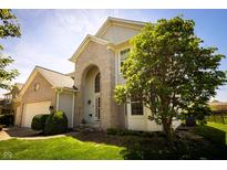 Charming two-story home with brick accents, arched entryway, and manicured landscaping at 11727 Wedgeport Ln, Fishers, IN 46037