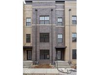 Newly constructed townhome with brick facade and multiple windows, awaiting final landscaping at 1216 N Alabama St, Indianapolis, IN 46202