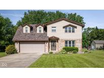 Charming two-story home featuring a brick and siding exterior with a well-maintained lawn and a two-car garage at 16226 Montrose Ln, Westfield, IN 46074
