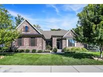 Charming brick home with well-manicured lawn and lush landscaping, complemented by a classic architectural design at 16890 Catkins Ct, Westfield, IN 46074
