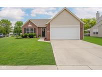 Charming single-story brick home with well-maintained lawn and attached two-car garage at 18760 Pilot Mills Dr, Noblesville, IN 46062