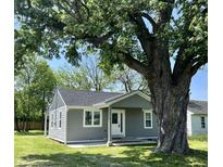Charming gray home with a mature shade tree in the front yard at 2417 Crystal St, Anderson, IN 46012