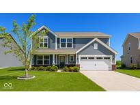 Charming two-story home featuring a manicured lawn, attached two-car garage, and beautiful curb appeal at 2780 Cormorant Dr, Greenwood, IN 46143