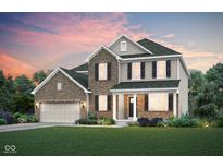 A beautiful two-story home featuring a brick and siding exterior, complemented by a lush green lawn at 3256 Fawn Cir, Brownsburg, IN 46112