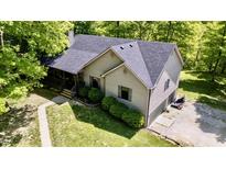 Two-story home featuring a covered front porch, tidy landscaping, and attached garage at 3273 Bailey Dr, Morgantown, IN 46160
