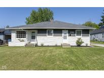 Charming single-story home with a well-maintained lawn and stone accents at 370 N Bazil Ave, Indianapolis, IN 46219
